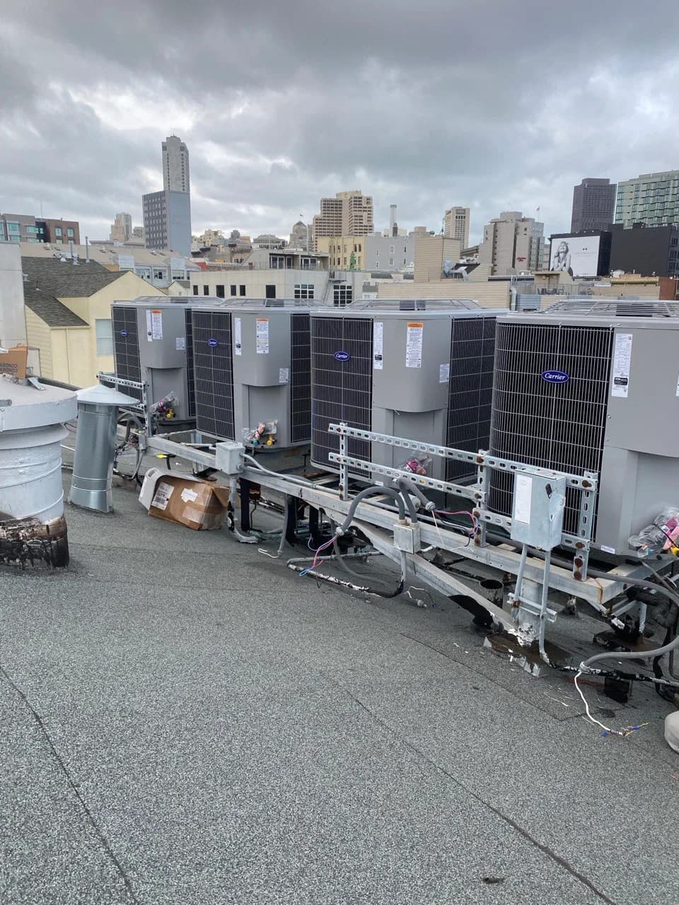 Rooftop air conditioning condensers next to a rooftop solar array