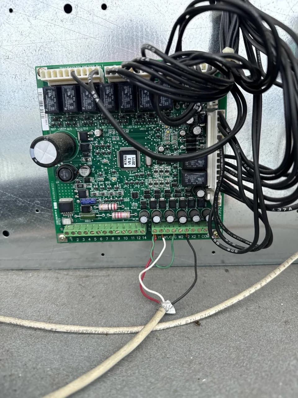 Control board and wiring harness inside an air handler cabinet