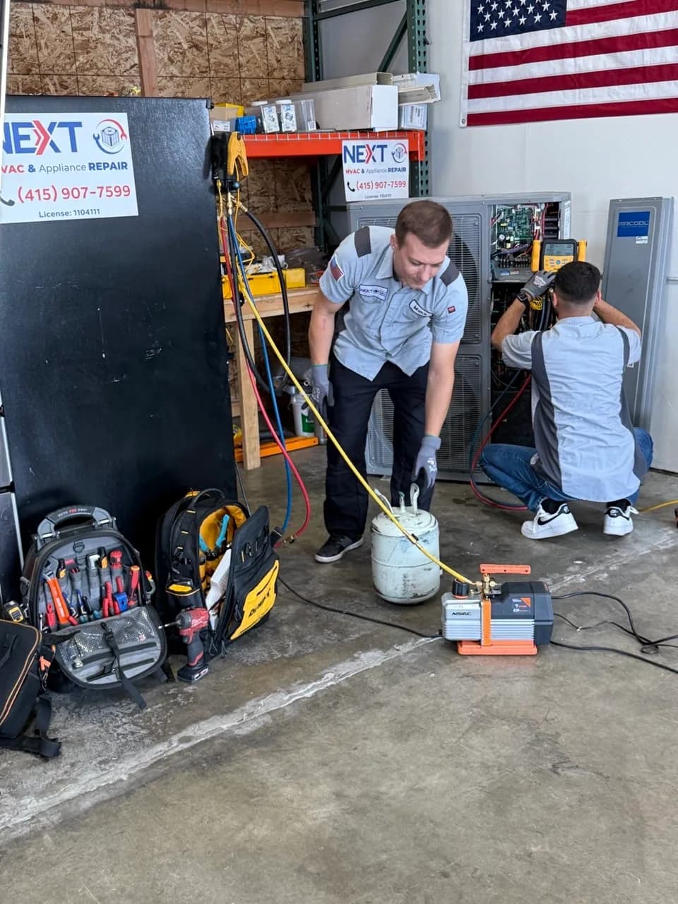 Technicians running start-up checks on heat pump units in the shop