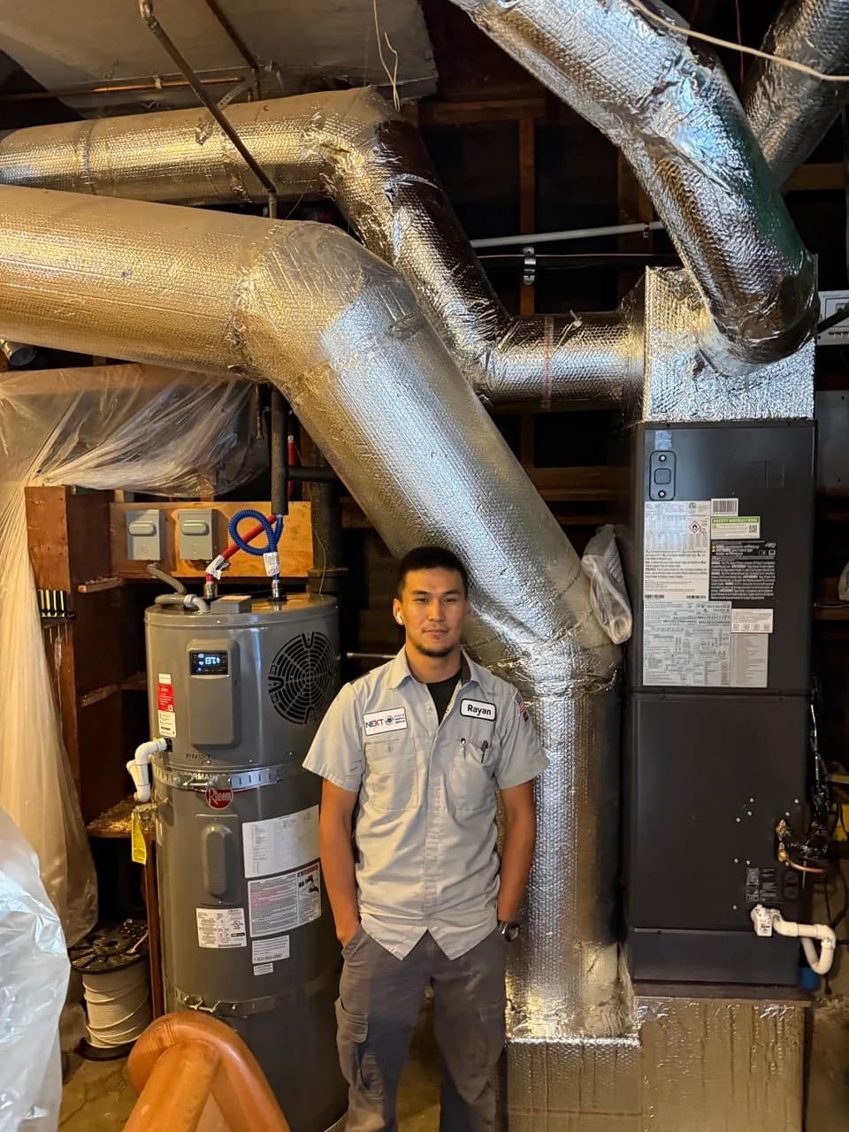 Insulated ductwork routed above a basement heat pump changeout