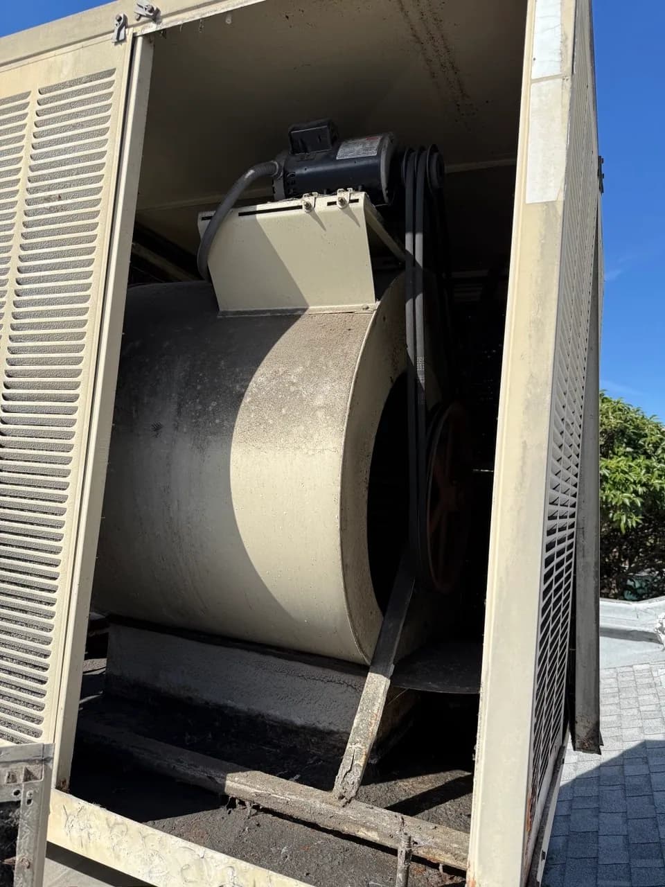 Blower wheel exposed for cleaning inside a commercial air handler