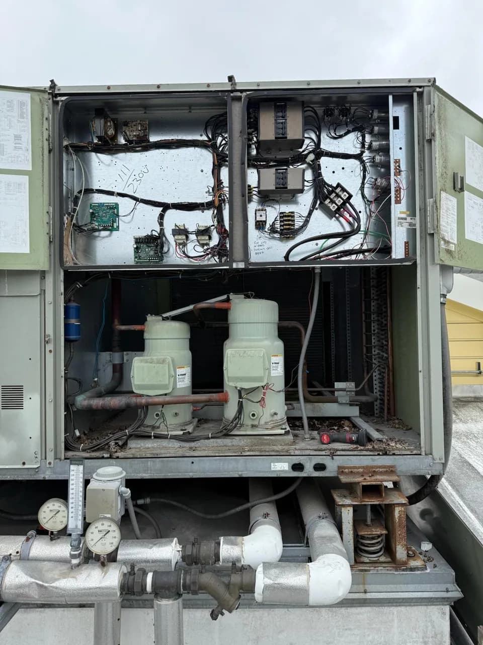 Compressors and contactors inside an opened rooftop unit