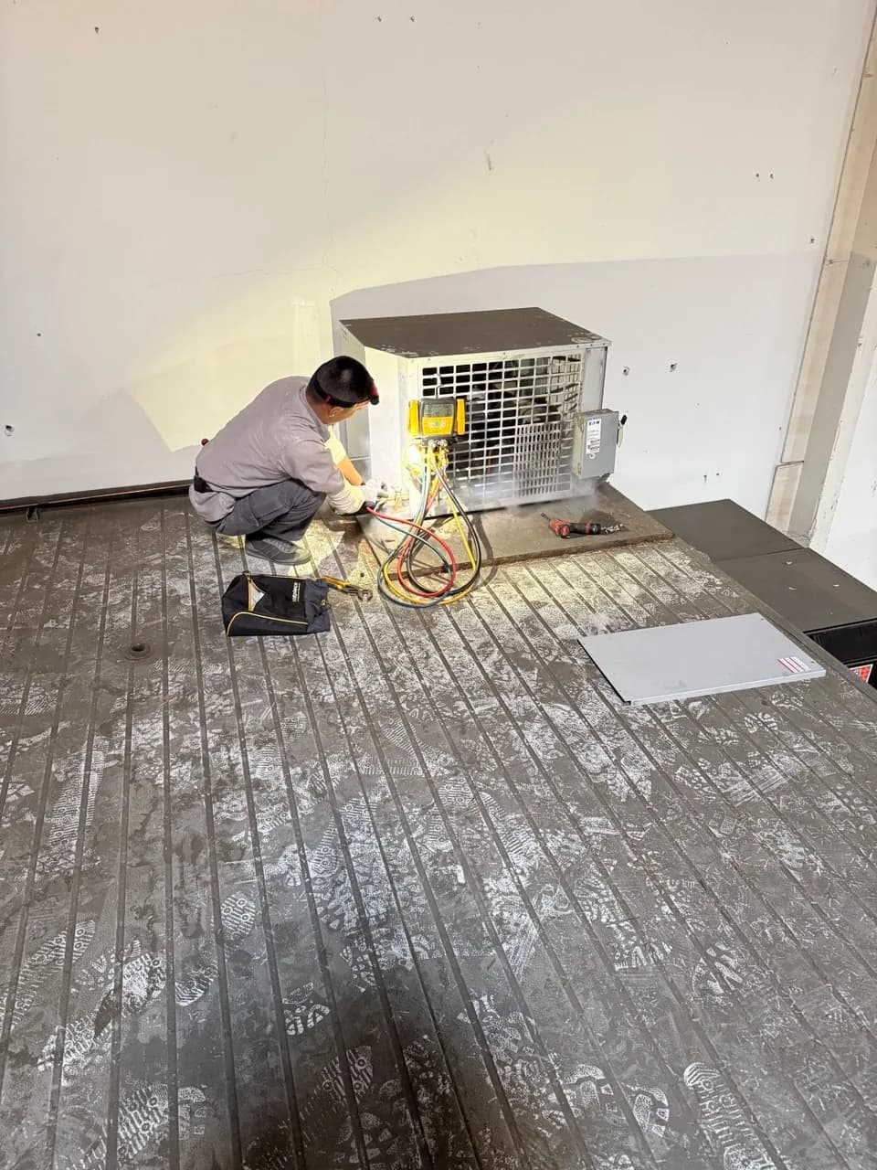 Technician commissioning a walk-in cooler condensing unit